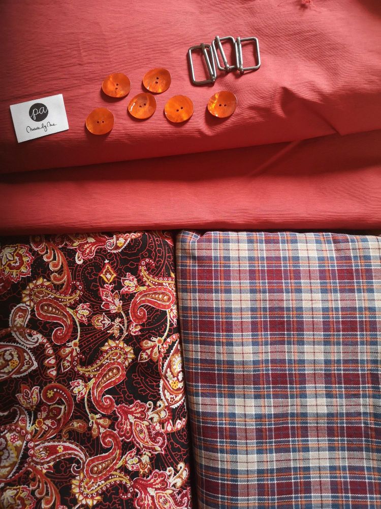 Photo of fabrics, buttons, a garment label and slide buckles