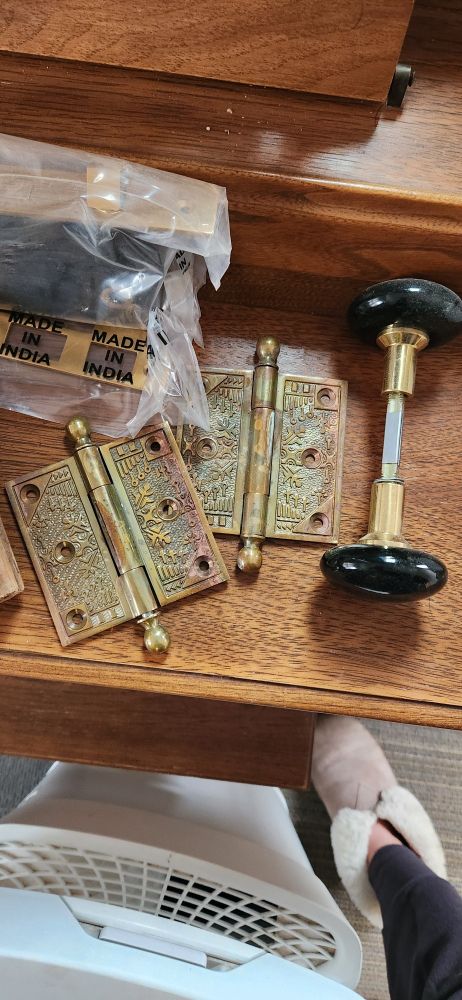 Reproduction Eastlake Victorian hinges in brass and black porcelain doorknobs