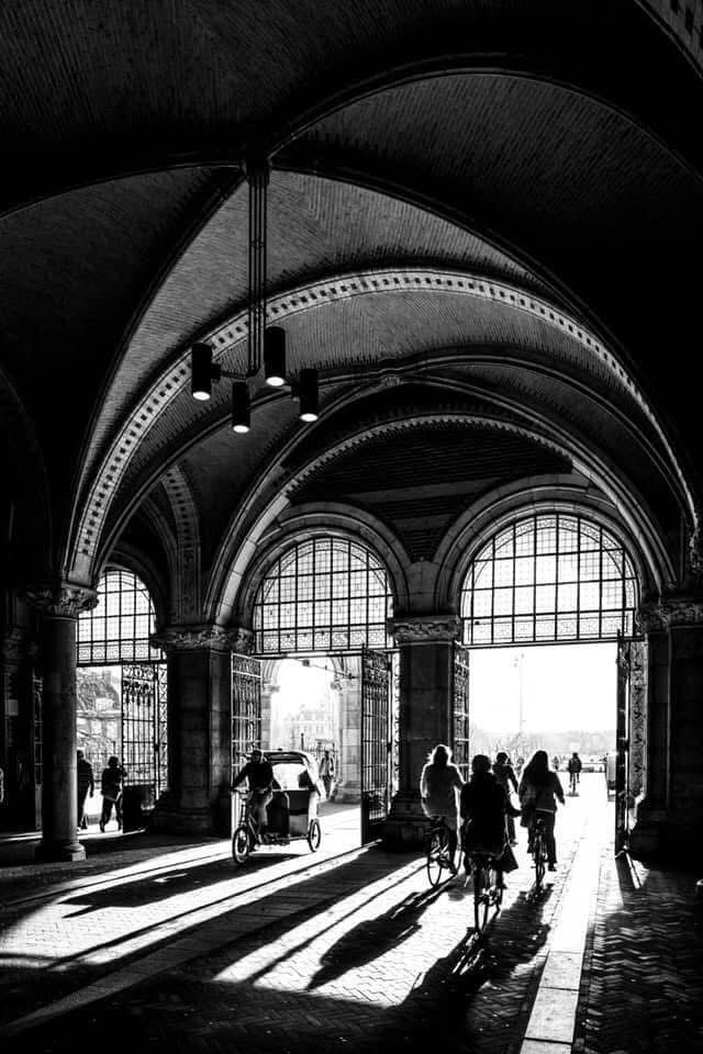 Cyclists under the passage of the Rijksmuseum in Amsterdam. Black and white photos.