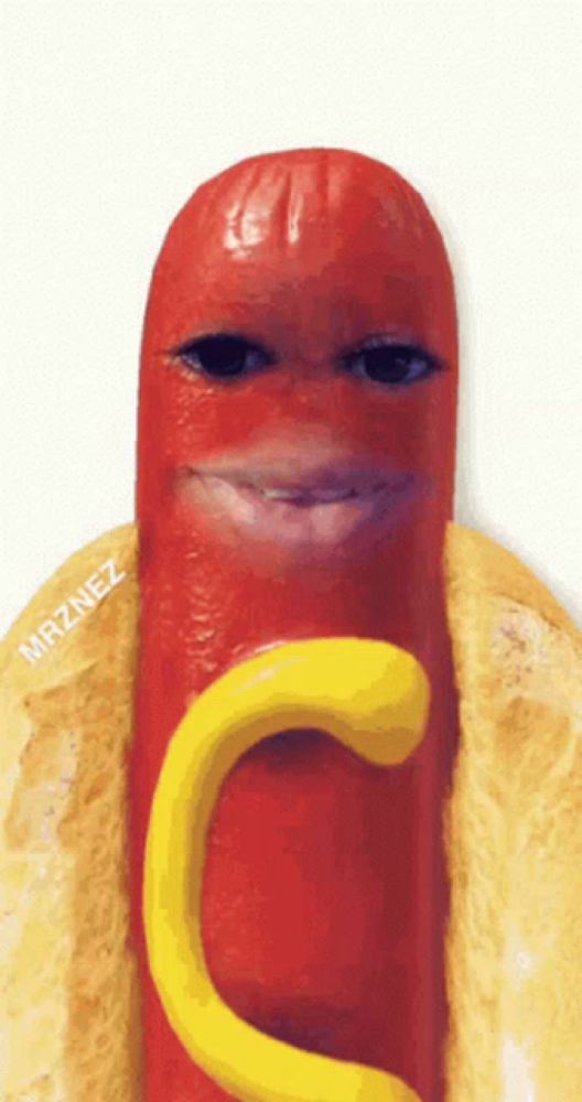 a hot dog on a bun with mustard and a face made out of it