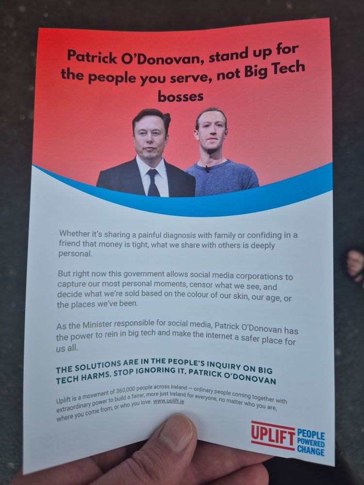Image of a flyer being handed out by Uplift ireland to minister Patrick O'Donovan 