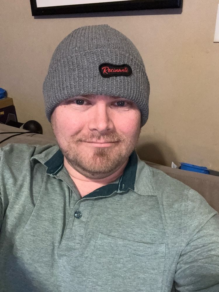 Gray “Rocinante” winter cap on a man’s head