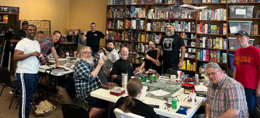 The group of two tables of players and DMs for the afternoon game.