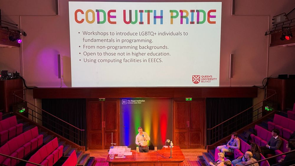 Jonathan presenting a slide about the plan for CODE WITH PRIDE that says. 
• Workshops to introduce LGBTQ+ individuals to fundamentals in programming.
• From non-programming backgrounds.
• Open to those not in higher education.
• Using computing facilities in EEECS.