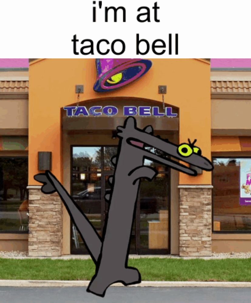 a picture of a taco bell with a cartoon character in front of it