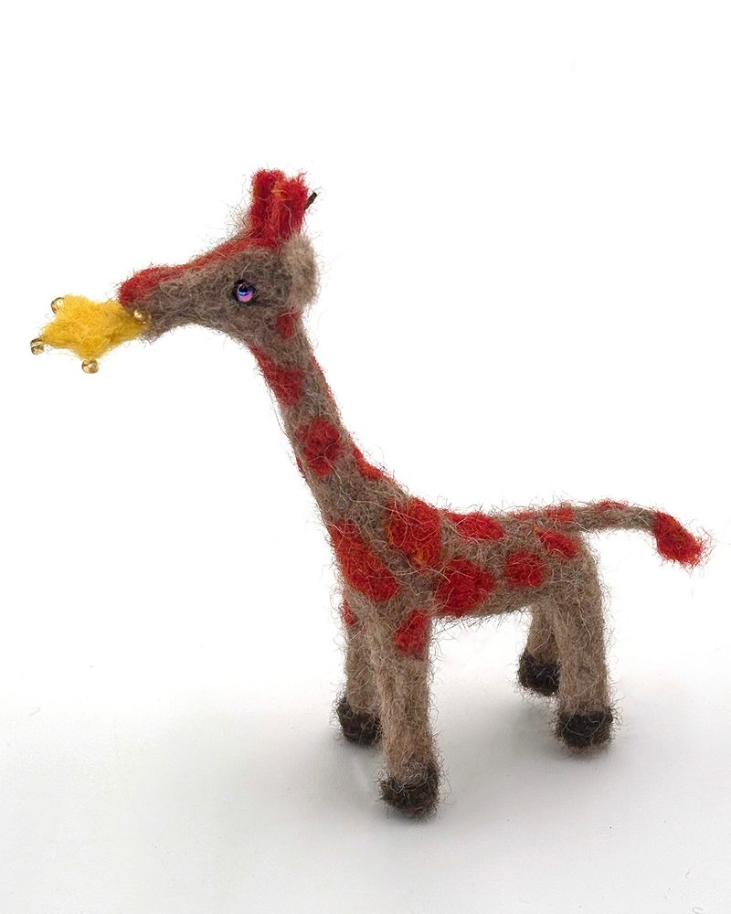 Star Girraffe(2025) One-of-a-kind needle felted holiday ornament by Lynn Wartski Natural and orange girrafe figure with gold star in mouth