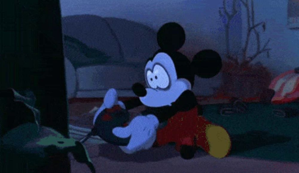 mickey mouse is playing a video game with a controller