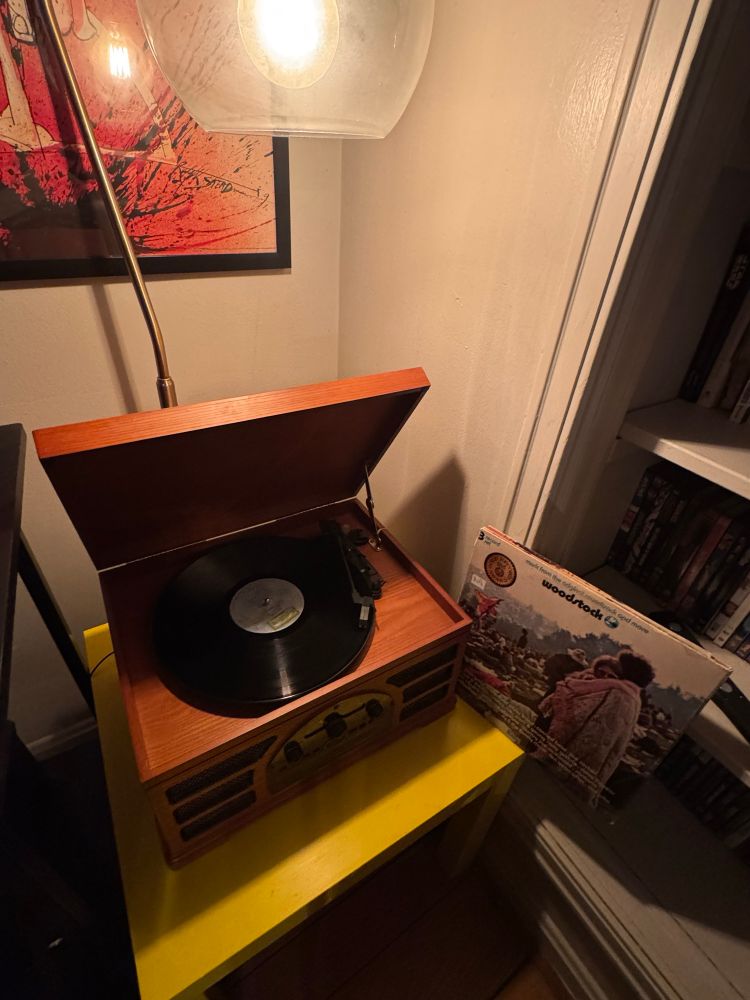 A vinyl record of the Woodstock festival spins on a turntable. 