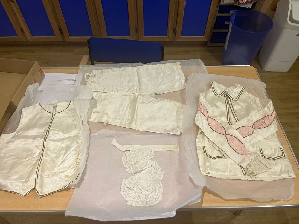 cream satin wedding outfit includes waistcoat, shorts and jacket. 