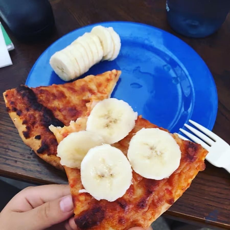 A slice of pizza with slices of banana on top