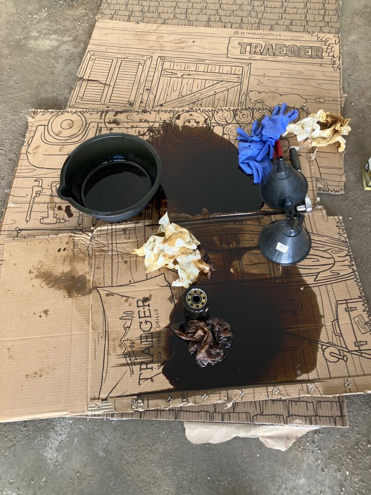 My cardboard with about a litre of black oil spilled, a few wads of paper towels and a couple pairs of gloves