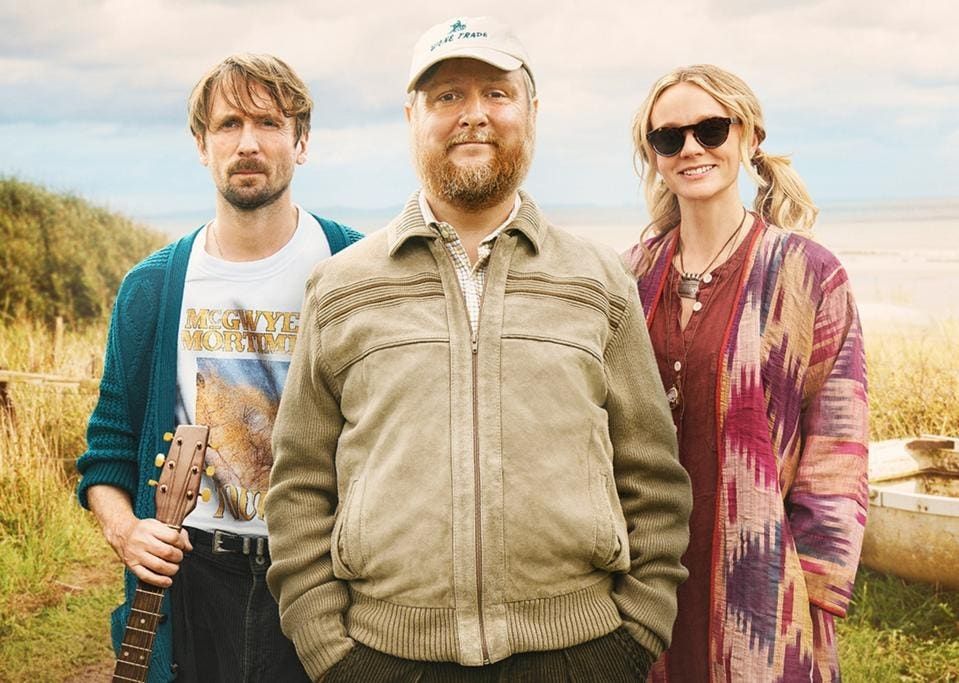 Poster for The Ballad of Wallis Island. Pictured are (l-r) the film's stars, Tom Basden, Tim Key and Carey Mulligan, on the titular island.