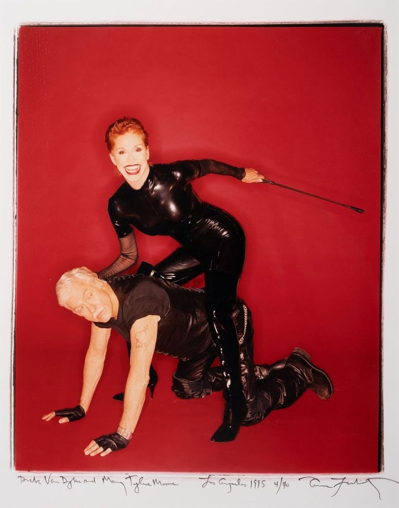 Dick Van Dyke on all fours being lorded over by Mary Tyler Moore while they both wear fetish fits in 1995