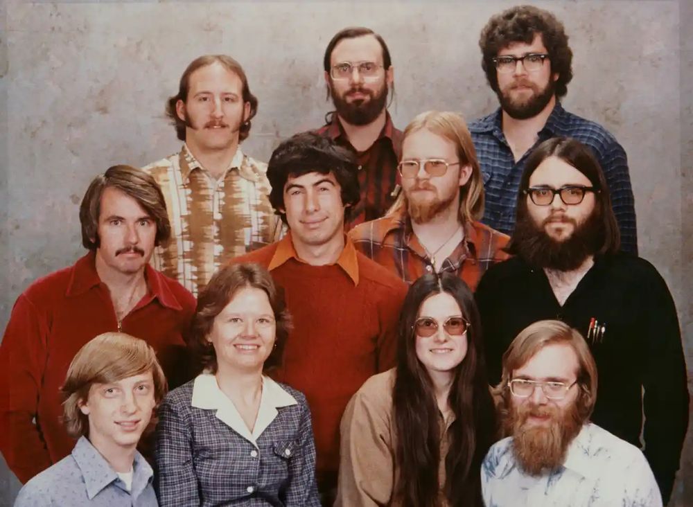 Photo of Microsoft staff in the 80s. Lots of long hair and beards. Looked comically awful 1995-2024 but they look pretty on trend for 2025.