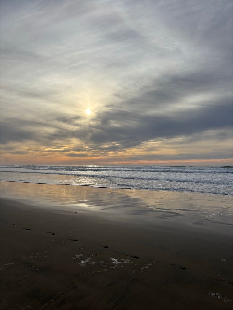 Peachy pacific sunset with light clouds
Crisp waves
