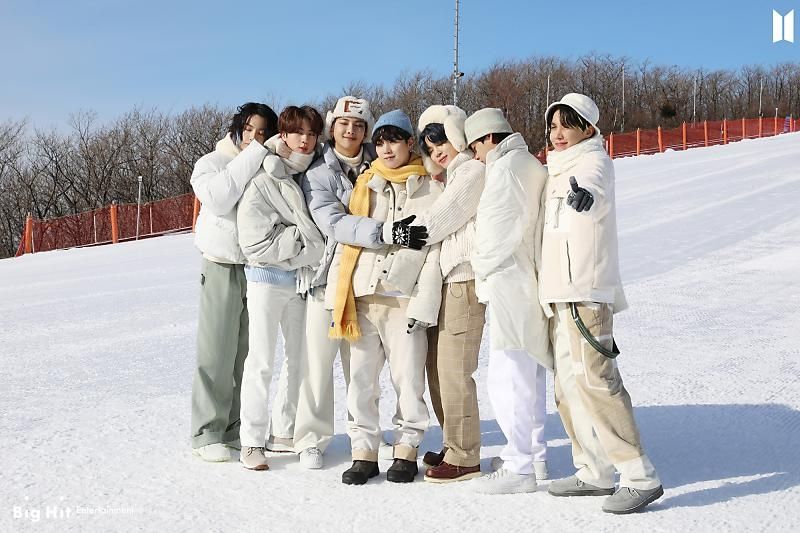 BTS dressed for winter, hugging Yoongi in the center