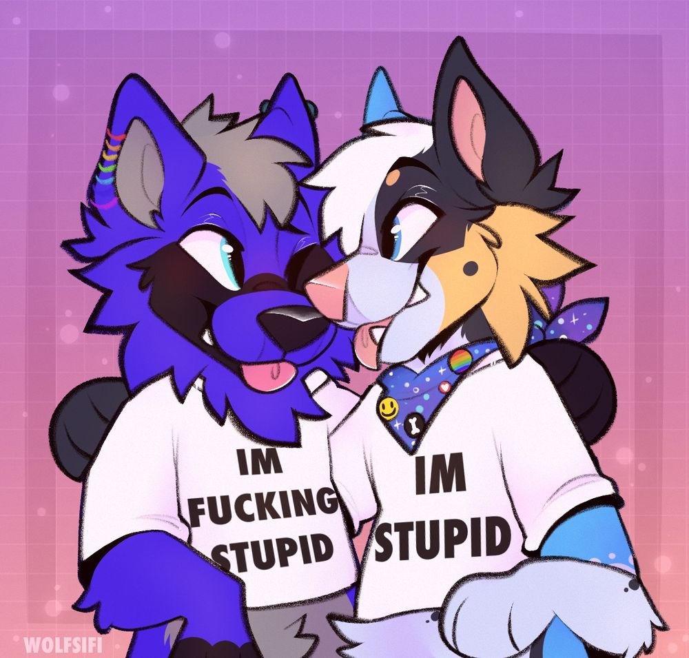 Jules the blue Heeler dog with his husband, Jae, the dark blue wolf. Jae is wearing a white t-shirt that says “I’m fucking stupid” and Jules is wearing a matching T-shirt that says “I’m Stupid”.