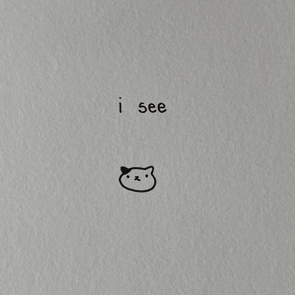 a doodle of a cat head with the words 