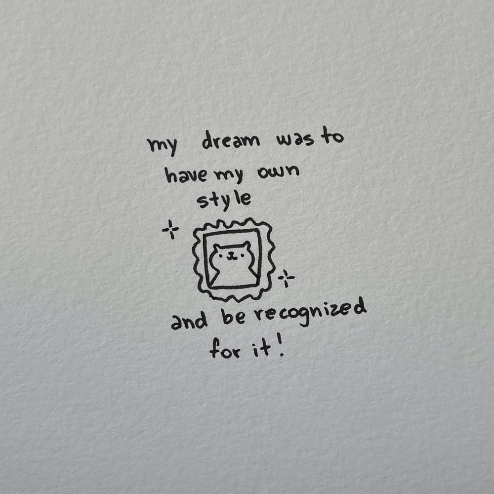 a framed poorly drawn cat, the text reads: “my dream was to have my own style, and be recognized for it!”