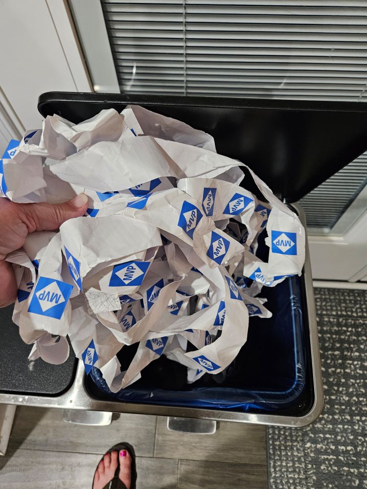 Rolls of destroyed stickers in the trash. 