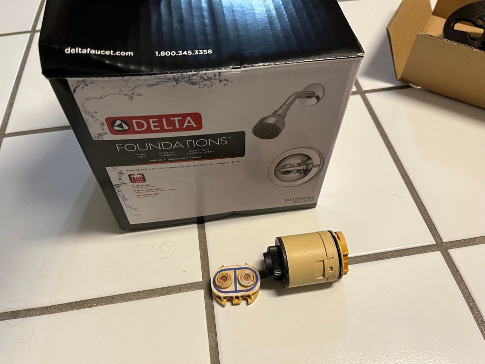 A shower faucet cartridge and a box for a new shower faucet