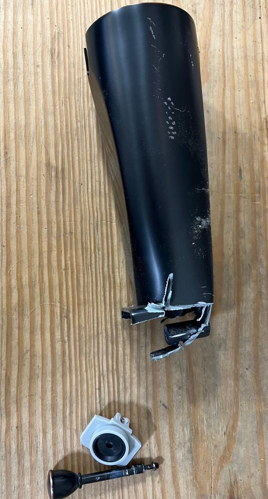 New tub spout with cut open tip on one side of the pic. The other side of the pic shows the liberated grey plastic diverter (and integrated round black rubber washer) and the accompanying diverter pull stem 
