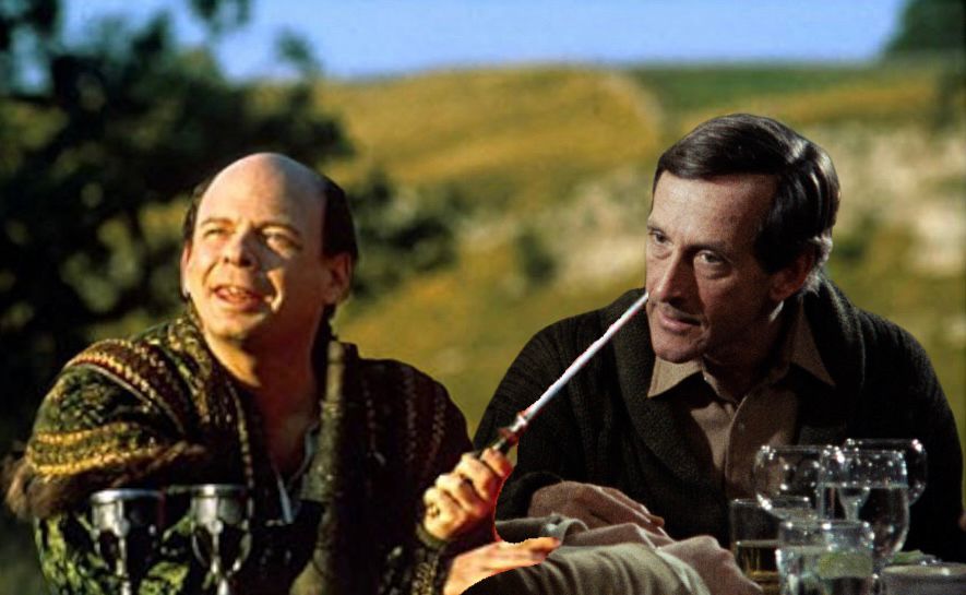 Wallace Shawn in the princess bride garb holding a rapier up to Andre Gregory from the movie my dinner with Andre 
