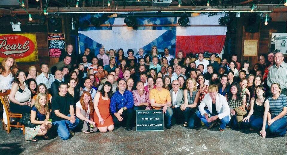 A photo of Robert Redford and the staff of Sundance Channel after its purchase by AMC Networks/Cablevision.