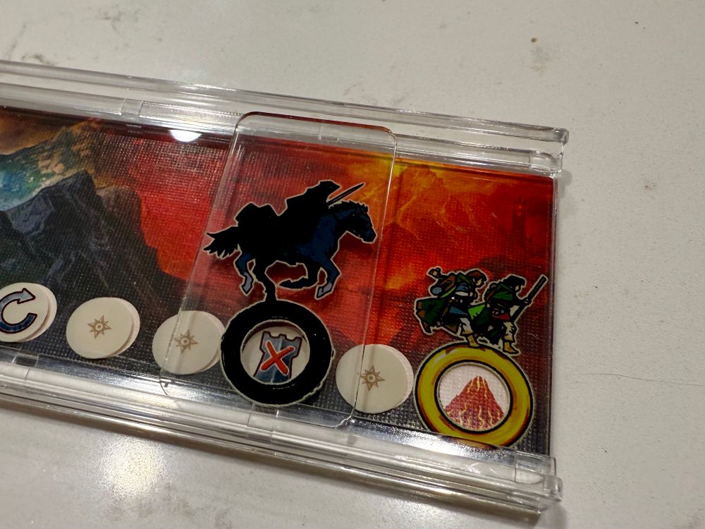 The ring tracker from the board game lord of the rings Duel showing the fellowship making it to Mt Doom with the Ringwraith only two spaces behind them. 