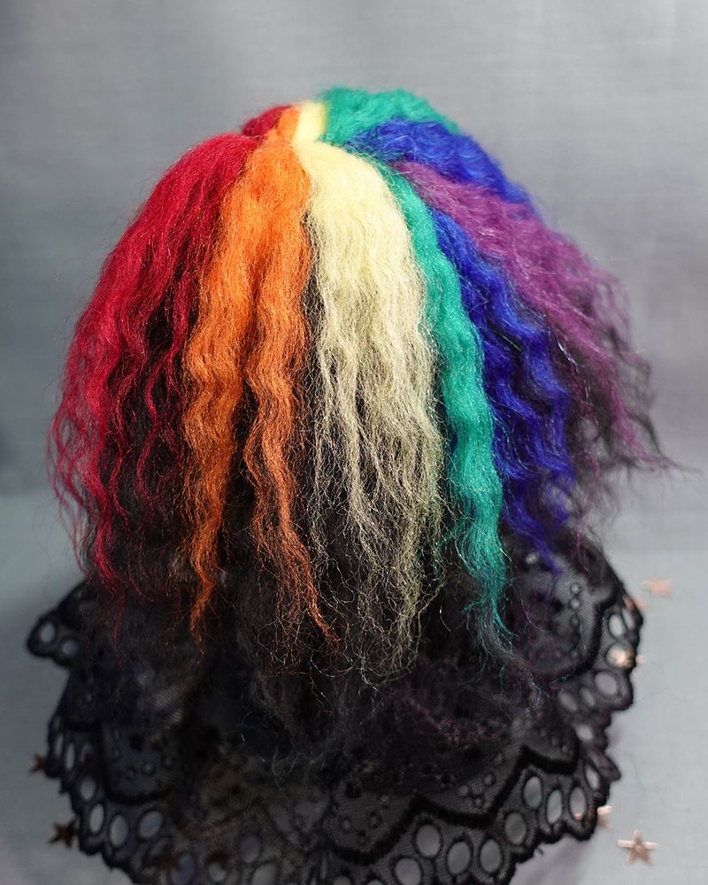 close up of rainbow coloured, long, wavy doll hair