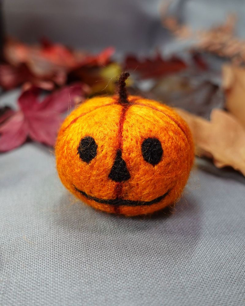 needle felted pumpkin with Jack o lantern face detail