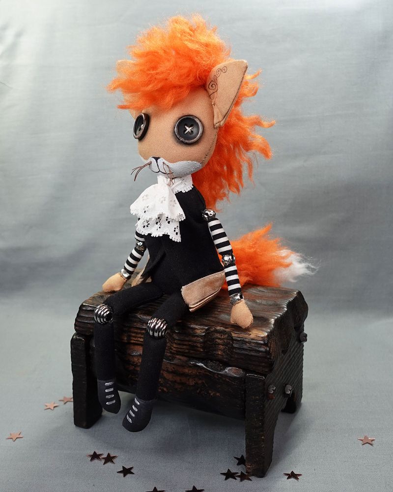 button eyed fox boy art doll with punky orange hair and frilled shirt