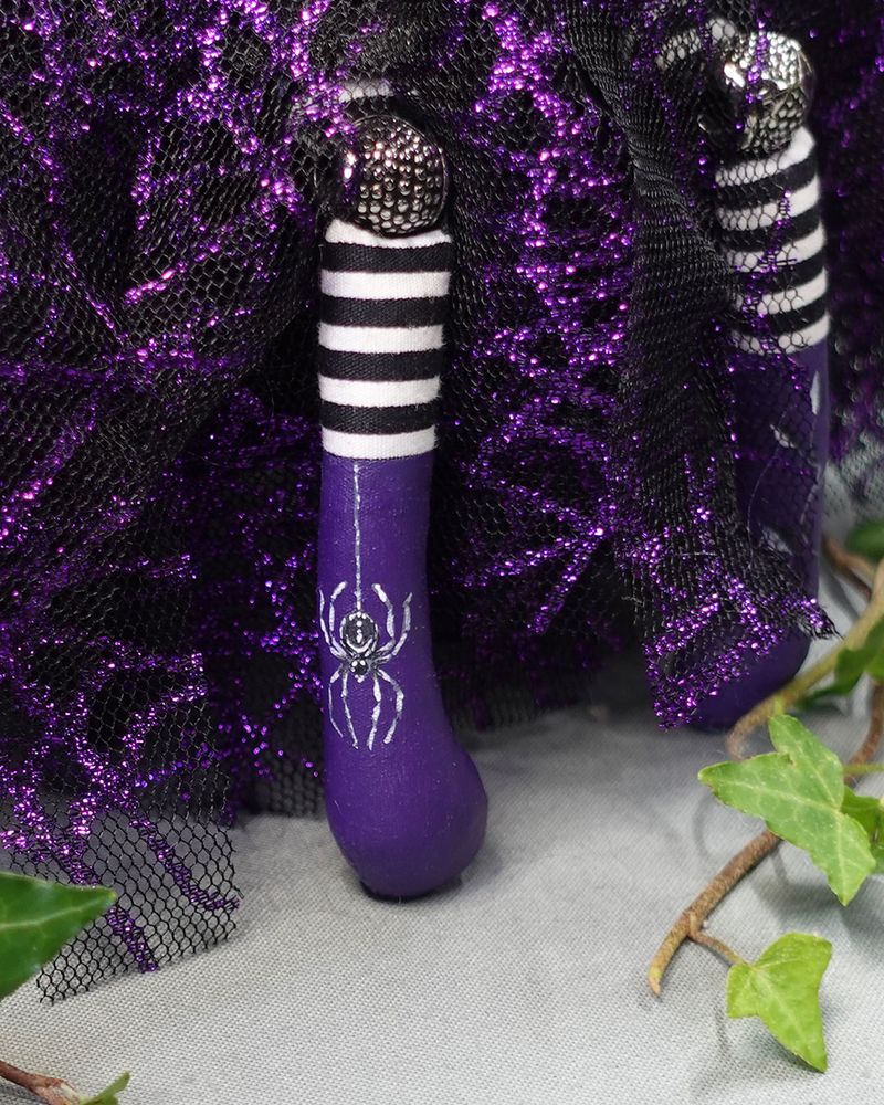 close up of doll's purple boot with hand painted spider design