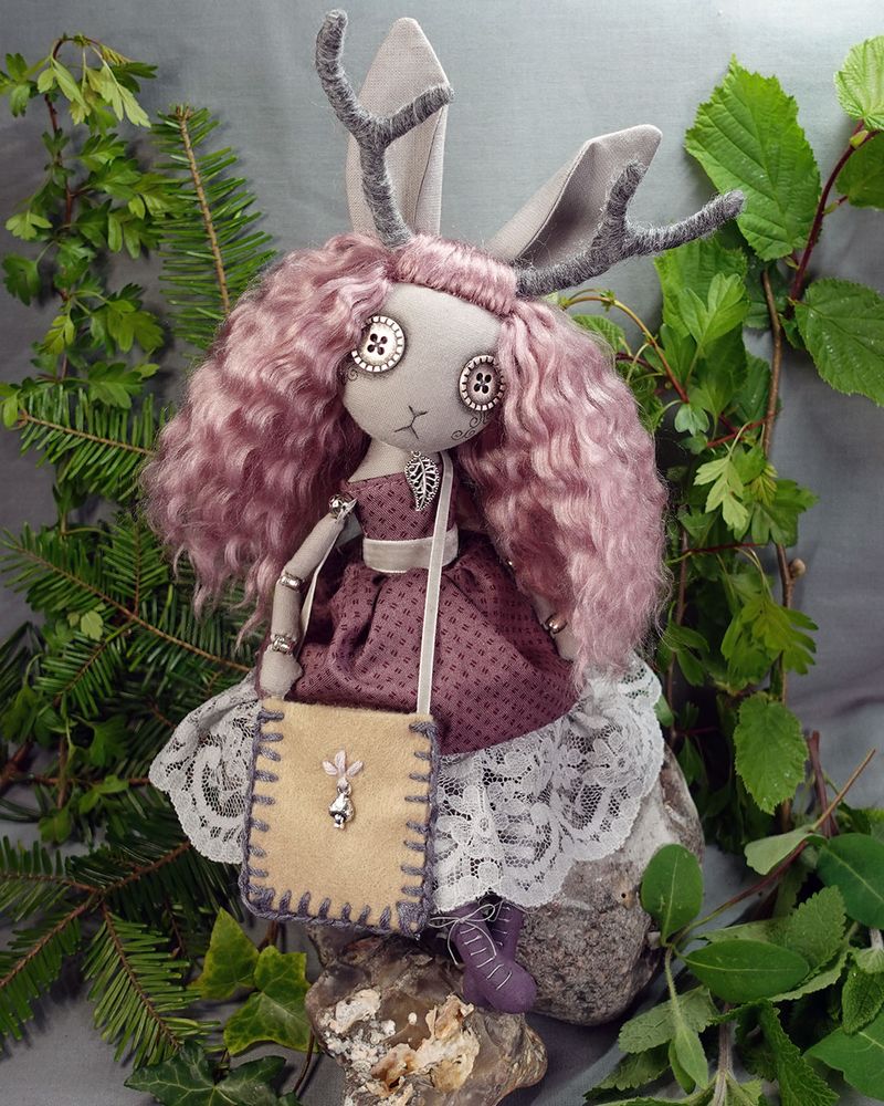 a button eyed jackalope art doll with dusky pink hair and rose coloured dress with hand stitched tote bag and lace up boots