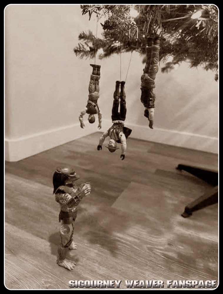 Toy Predator merking a bunch of soldier toys hanging from a Christmas tree.