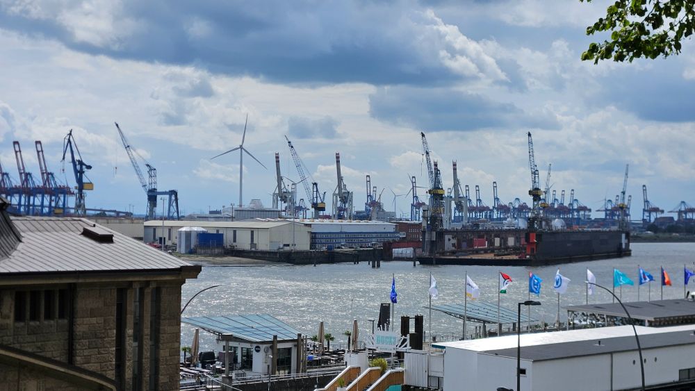 Elbe und Krane und eine Reihe flatternde Flaggen.