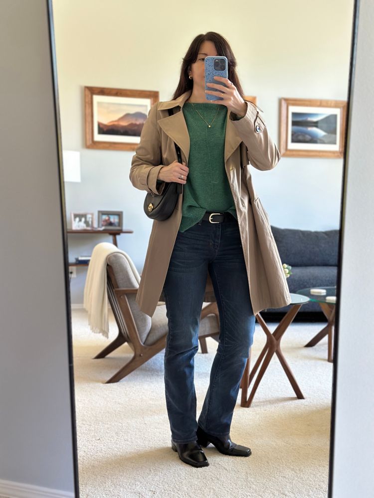 Woman wearing the Weekender Light sweater by Andrea Mowry with a khaki trench coat, black Madewell shoulder bag, Levi bootcut jeans and H&M black boots