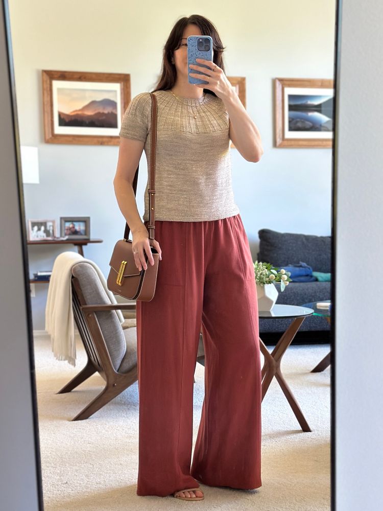 Woman wearing Sunday Tee with Linen Pants, Strappy nude sandals, and a Demellier Vancouver bag