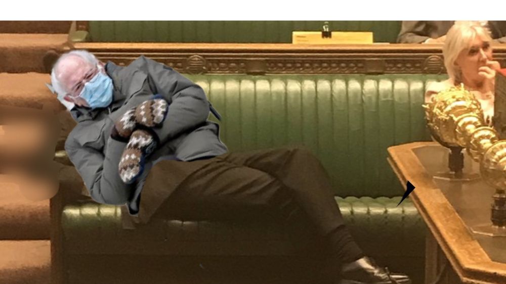 Bernie Sanders in mittens reclining in the Houses of Parliament to such an extent that he is almost laid down, much like Rees-Mogg