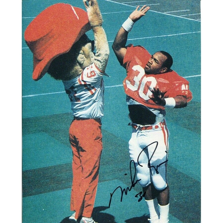 1983 Heisman Trophy winner Mike Rozier (r) high-fiving Nebraska mascot Herbie Husker.