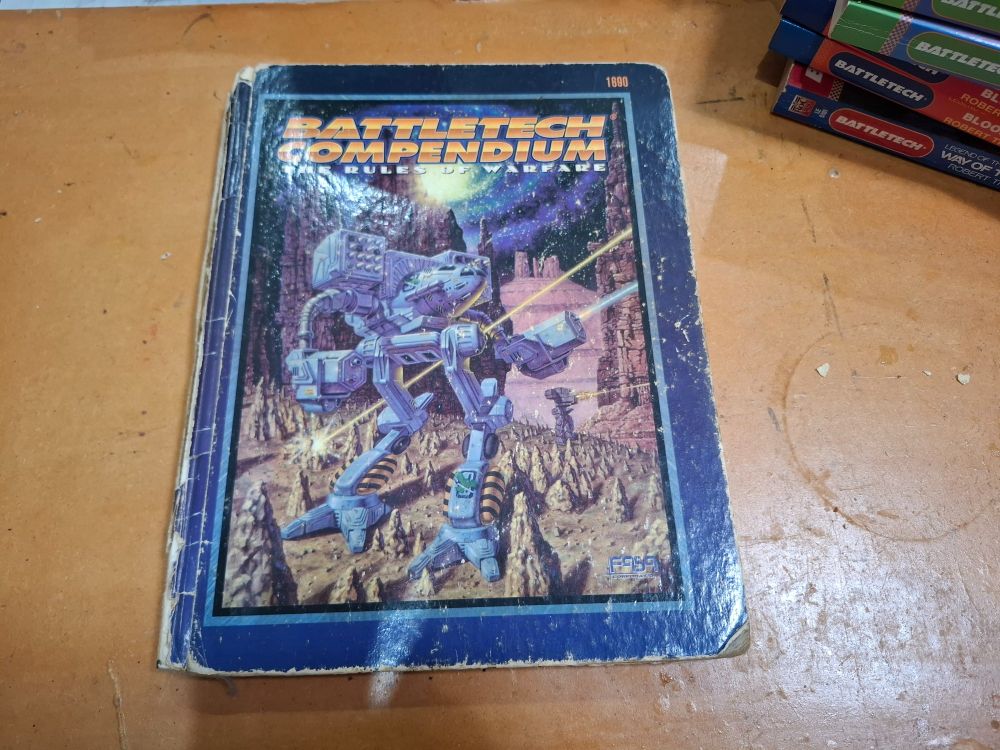 Battered and worn hardcover copy of BattleTech Compendium: The Rules of Warfare
