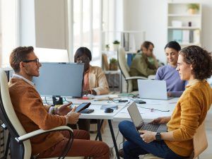 Several people sitting at a conference table during a meeting