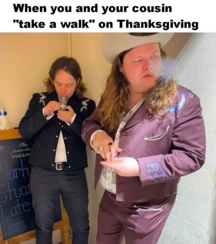 When you and your cousin "take a walk" on Thanksgiving - Billy Strings and Marcus King smoking weed

Billy Strings is smoking weed from a glass pipe and wearing dark blue jeans with a blue cowboy-printed blazer. Marcus King is exhaling smoke to the right and is wearing a red Western embroidery blazer with decorative trim, similar colored pants, and a cowboy hat. Both men are Caucasian with longer hair.