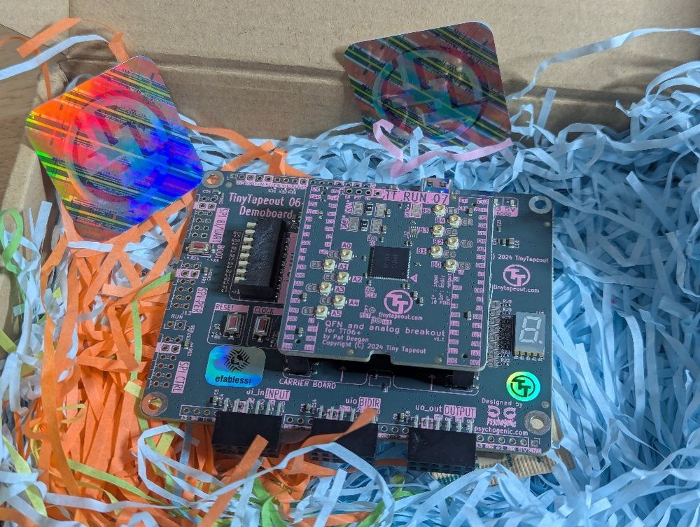 Opened box with tinytapeout board inside.