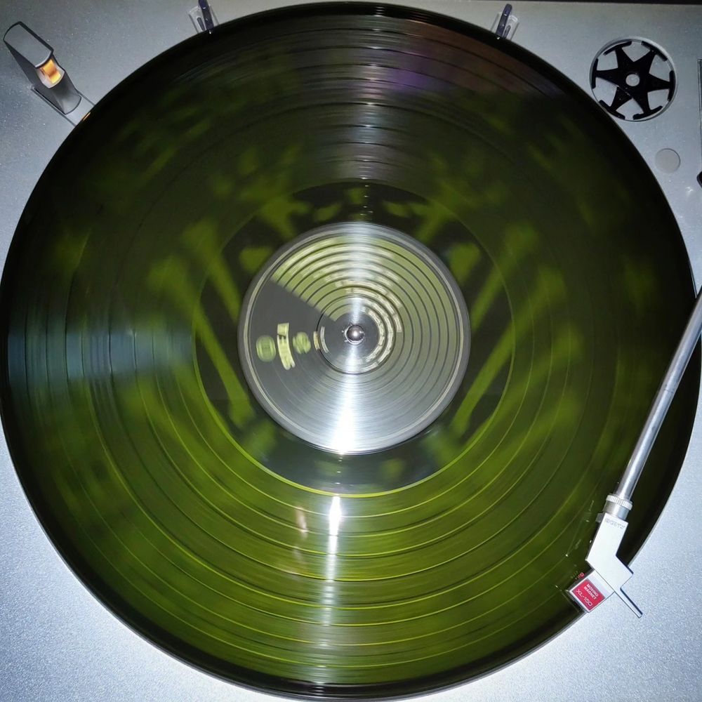 First vinyl disc on the player, lightly transparent. You can see the slipmat shining through showing the "Knochenadler" by "Die Toten Hosen".