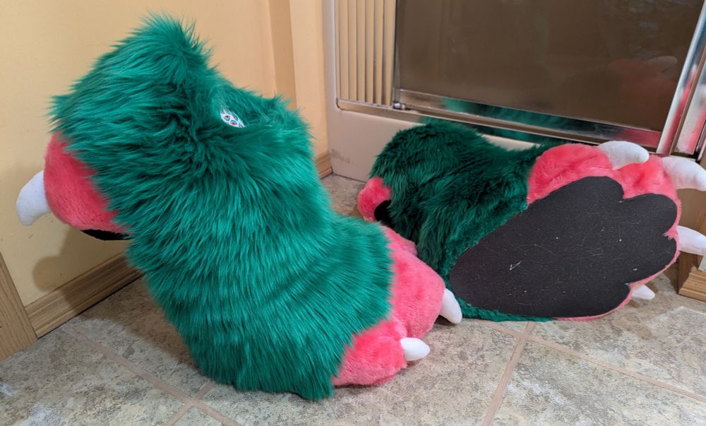 A set of green and pink digitigrade outdoor fursuit feet paws. A side and bottom view.