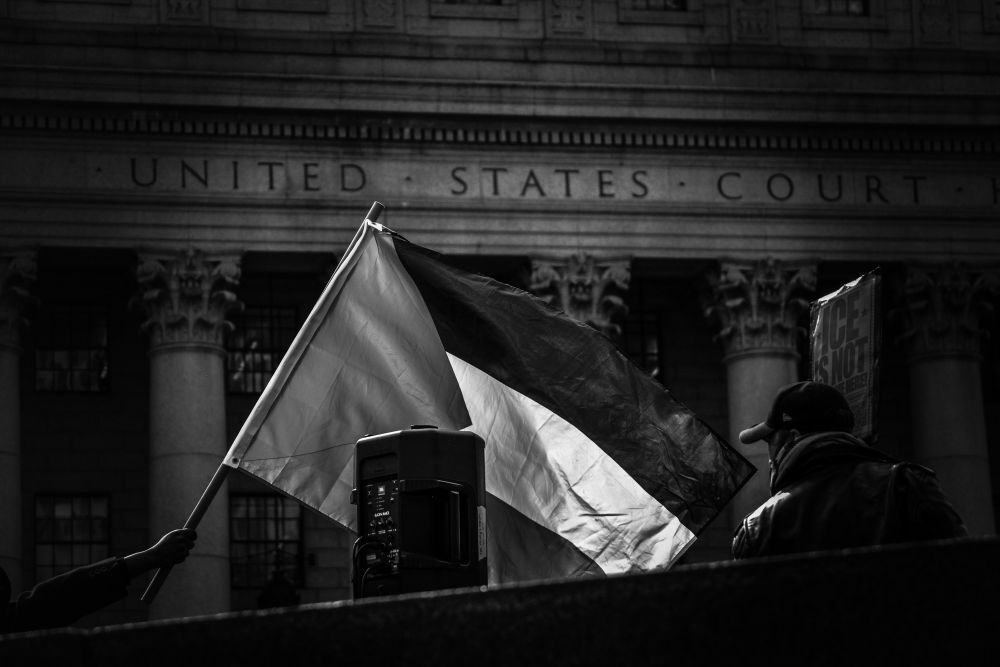 Palestinian flag being waved at a rally in Lower Manhattan.