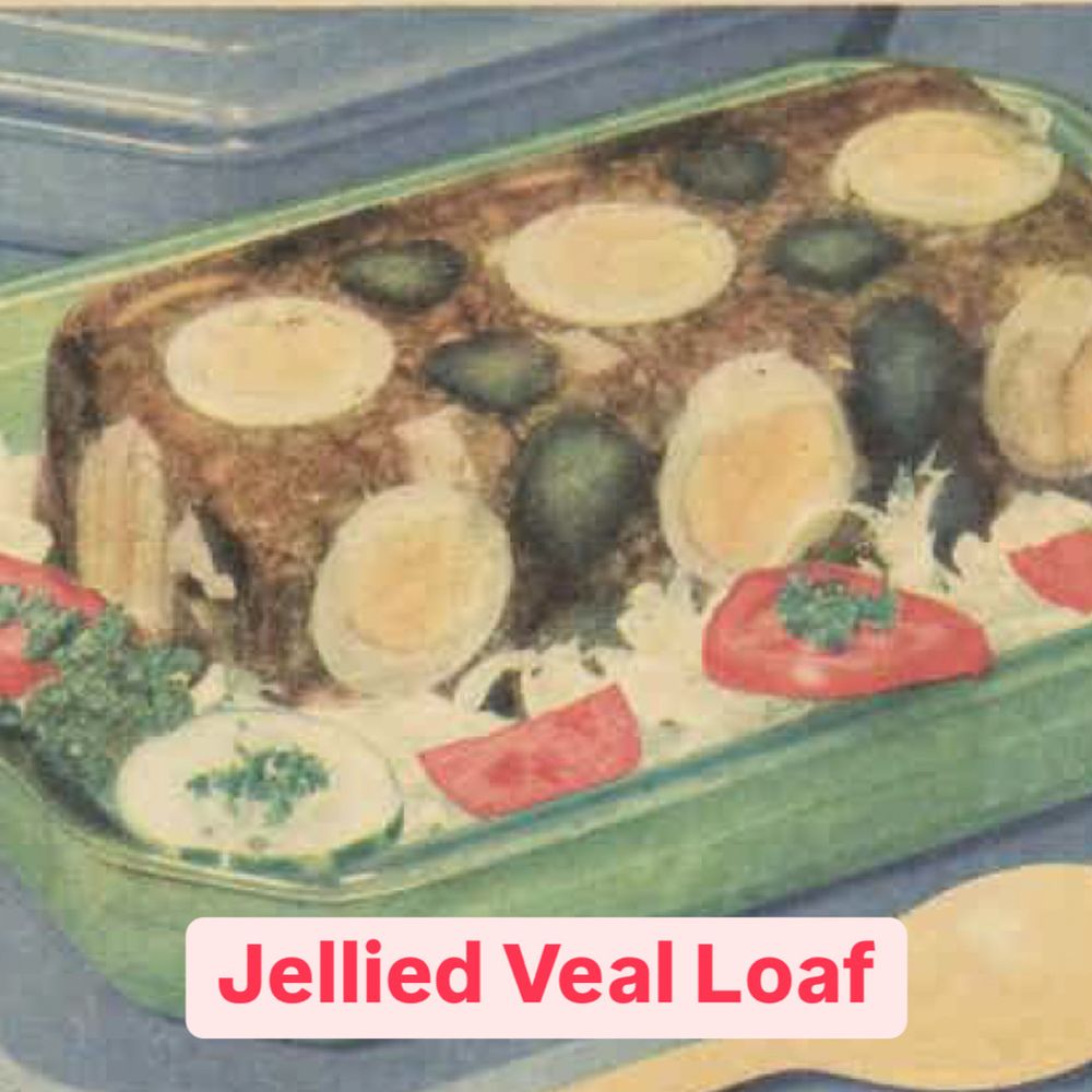 A loaf made of jelly, eggs and gherkins surrounded by salad. 