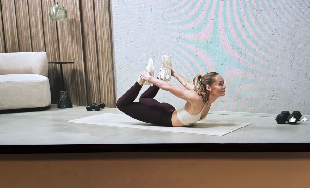 Workout Queen doing a very difficult stretch