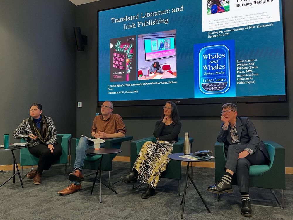 Four people seated beneath a display showing a slide titled “translated literature and Irish publishing”. From L to R: Dr Jivanta Schottli, Dr Tim Groenland, Prof Porscha Fermanis and Prof Danielle Clarke. At the National Library of Ireland